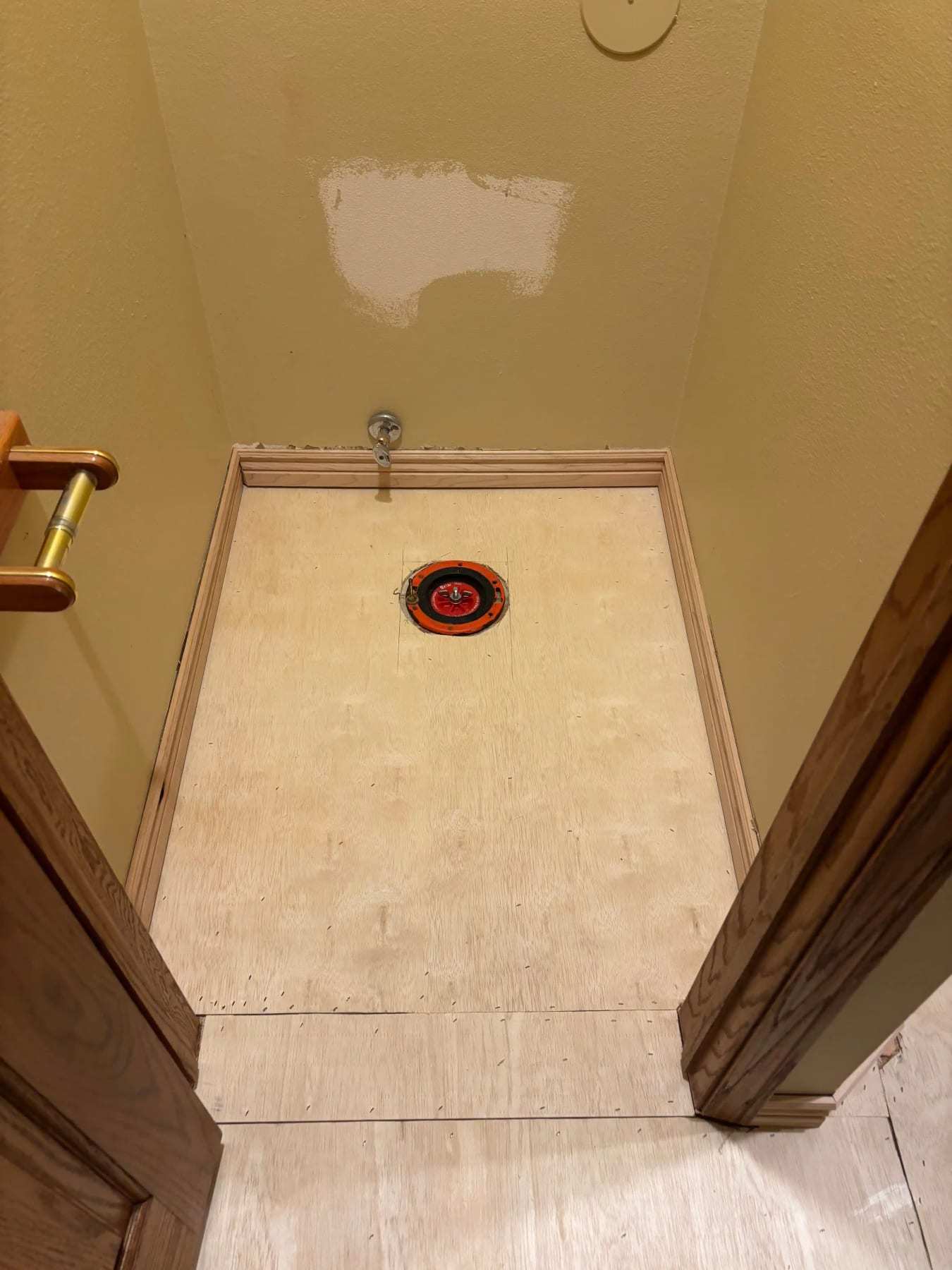 Bathroom with the toilet removed and the flooring taken down to the subfloor